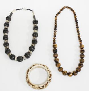 Appraisal: Ethnographic Jewelry Articles Beaded necklaces of tiger's eye and carved