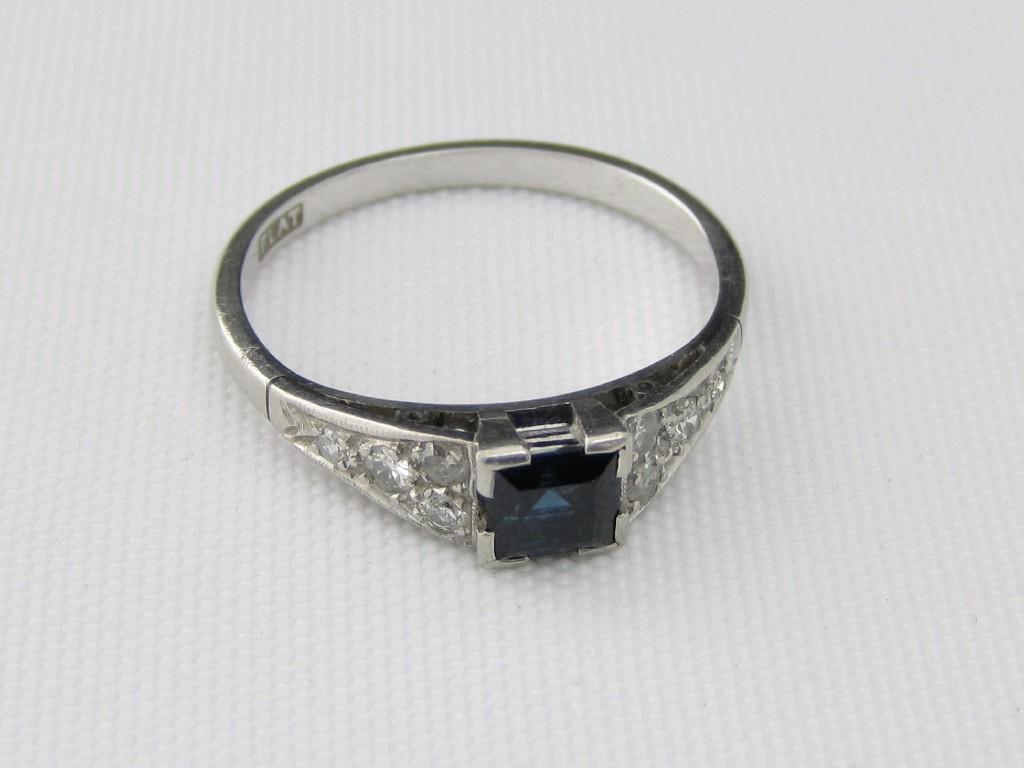 Appraisal: A Sapphire and Diamond Ring the central square-cut sapphire between