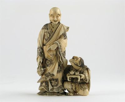 Appraisal: A Japanese ivory carving of a sorcerer wearing finely decorated