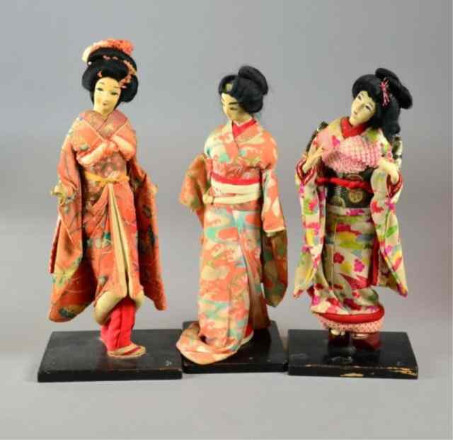 Appraisal: JAPANESE GEISHA DOLLS ON STANDSThree typically dressed geisha dolls on