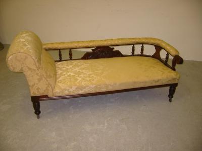 Appraisal: AN EDWARDIAN WALNUT FRAMED SOFA upholstered in yellow damask covering