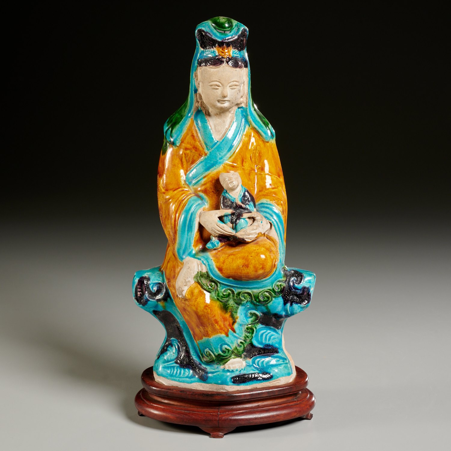 Appraisal: CHINESE FAHUA GLAZED GUANYIN WITH CHILD Possibly Ming Dynasty or