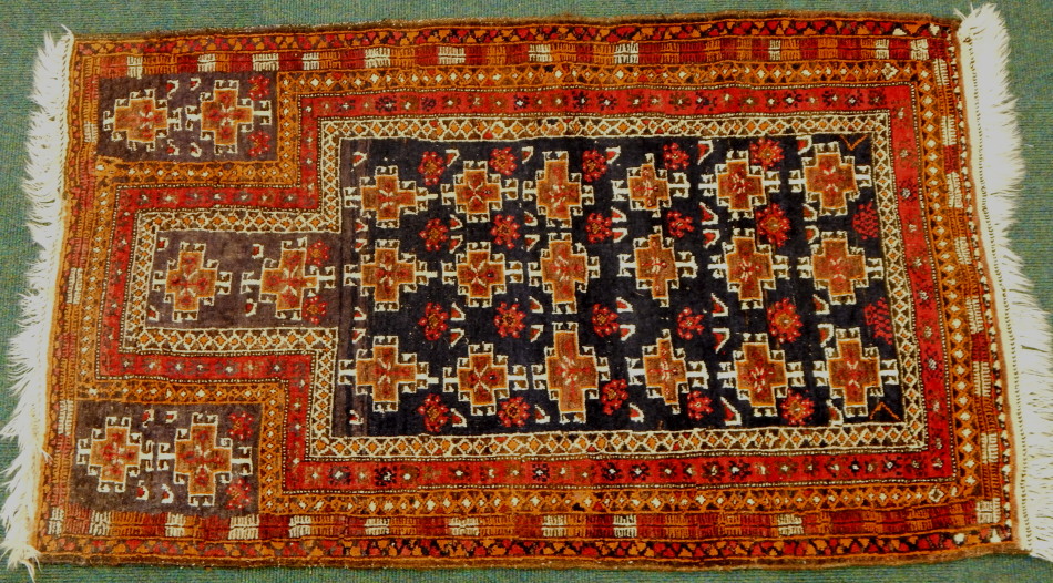 Appraisal: A thC Middle Eastern rug predominately in red blue and