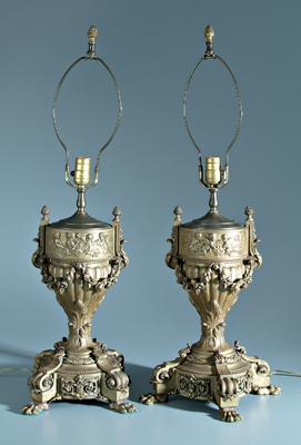 Appraisal: Pair bronze dor lamps urns with floral swags below frolicking