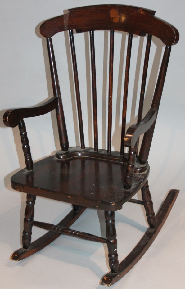 Appraisal: An early thC stained beech child's rocking chair with spandrel