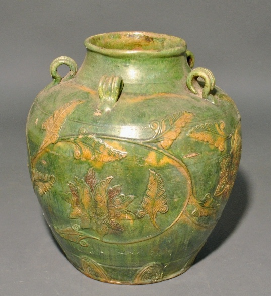 Appraisal: - Early Asian green glazed pottery pot with relief floral