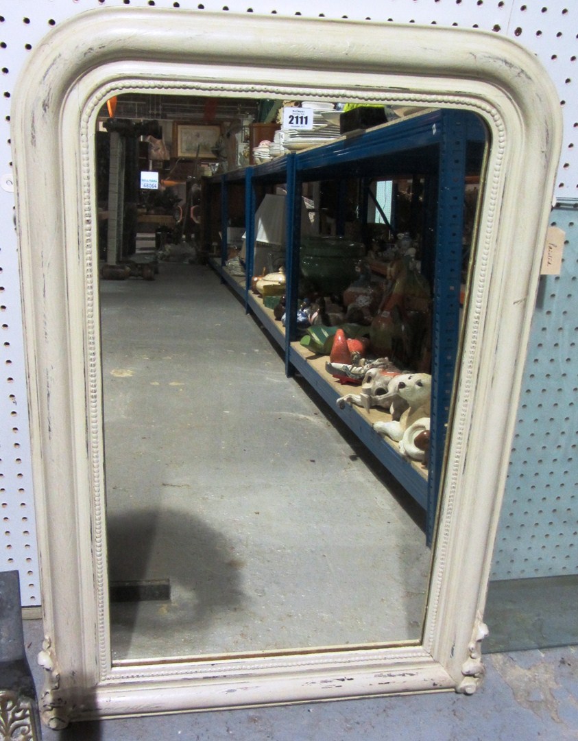 Appraisal: A cream painted mirror with an octagonal carved mirror and