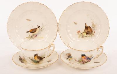 Appraisal: A pair of tea cups and saucers painted birds in