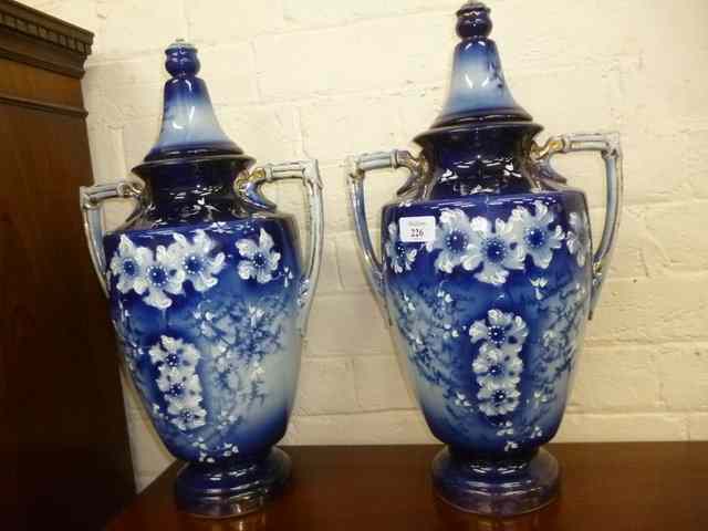 Appraisal: A PAIR OF VICTORIAN POTTERY URNS decorated in blue and