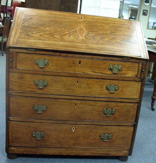 Appraisal: An early th Century oak bureau with fitted interior beneath