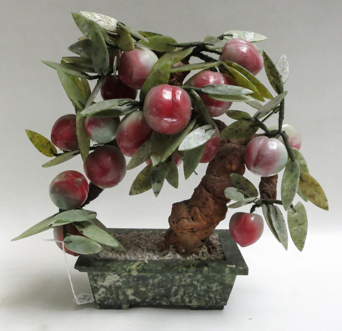 Appraisal: CHINESE HARDSTONE FRUITING JADE TREE having peaches and leaves on