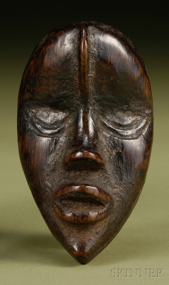 Appraisal: African Carved Wood Passport Mask Dan the ovoid form with