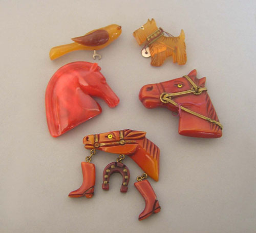 Appraisal: Three Bakelite and lucite red horse pins scottie dog and