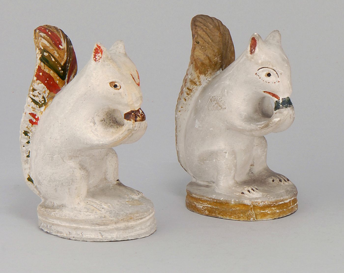 Appraisal: TWO SIMILAR CHALKWARE FIGURES OF SQUIRRELS Paint differing Heights