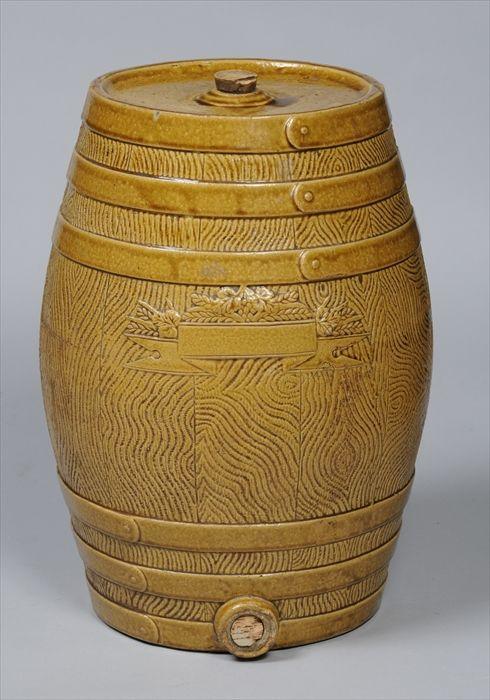 Appraisal: OCHRE-GLAZED STONEWARE SPIRIT BARREL The oak-textured body with six bands