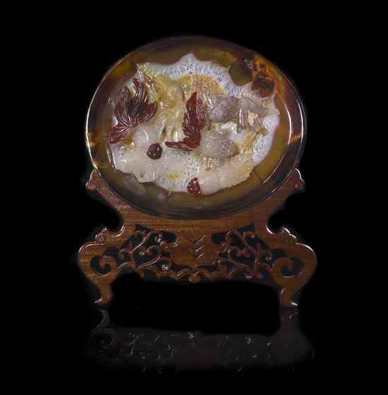 Appraisal: An Agate Plate having high relief decoration to the center