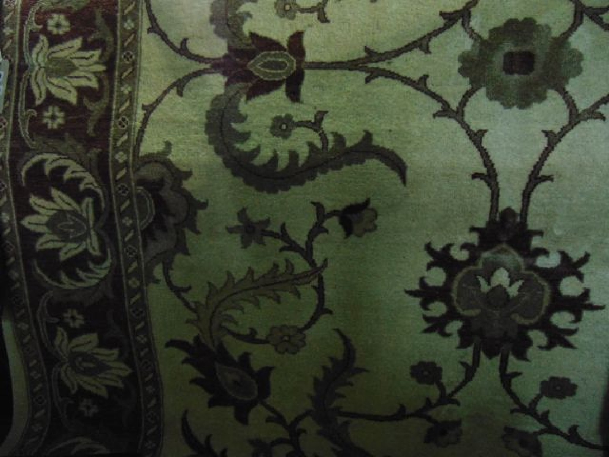 Appraisal: An eastern style cream ground wool carpet with scrolling foliate