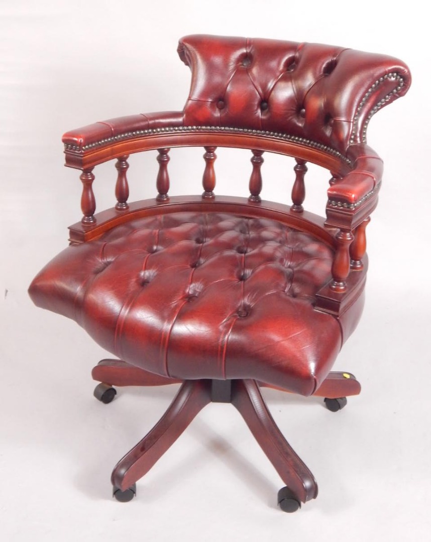 Appraisal: A mahogany and red leather swivel office chair with button