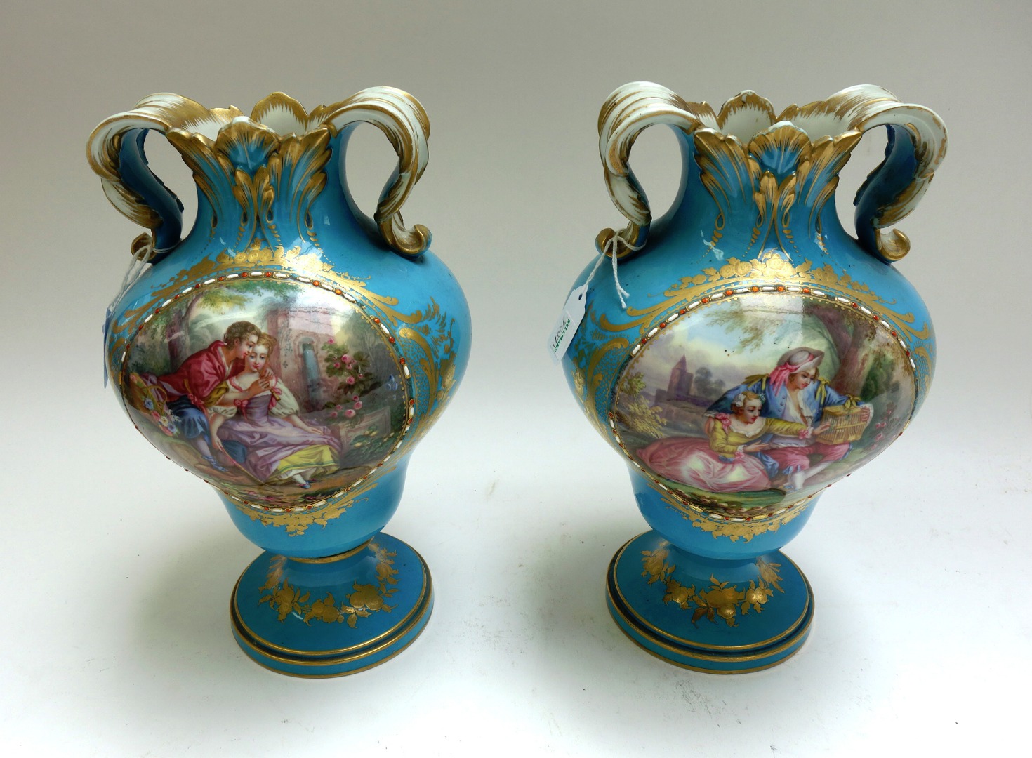 Appraisal: A pair of Sevres style bleu celeste ground two handled