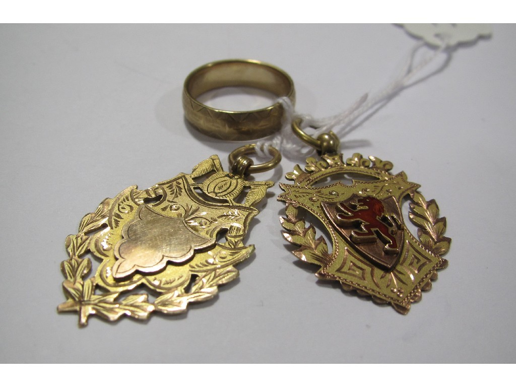 Appraisal: Two ct gold presentation medals and a wedding band Approximately