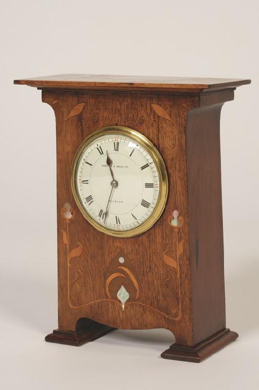 Appraisal: AN ART NOUVEAU CASED MANTEL CLOCK the white convex dial