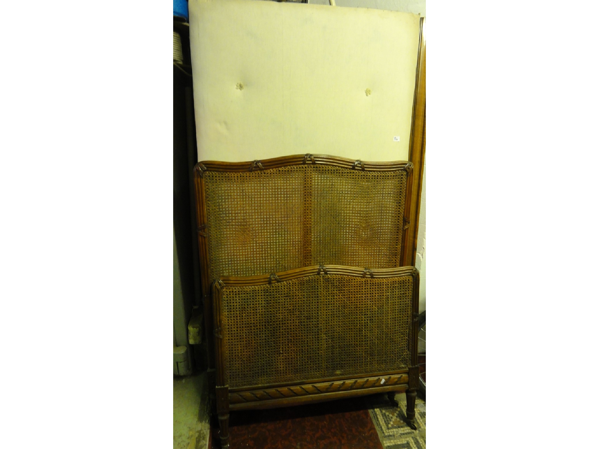 Appraisal: A th century walnut single bedstead the cane panelled headboards