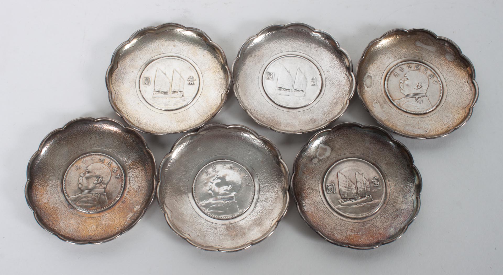 Appraisal: Six Chinese silver miniature dishes incorporating Republican silver coins in