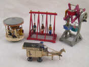 Appraisal: Four wooden operating toys being swingboats a roundabout a horse