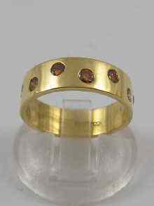 Appraisal: A hallmarked ct gold band ring set with coloured diamonds