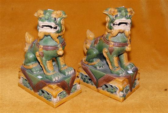 Appraisal: PAIR OF GREEN AND MUSARD GLAZED FOO LIONS h EACH