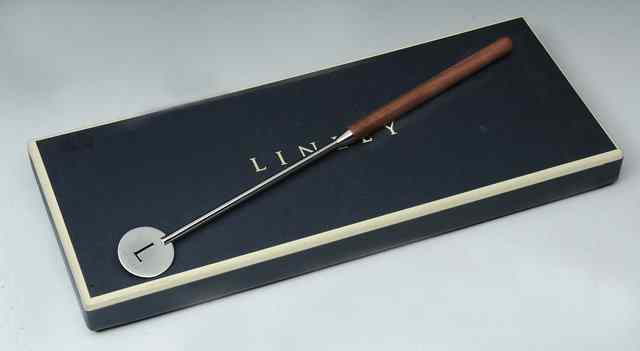 Appraisal: A David Linley cocktail stirrer in stainless steel with walnut