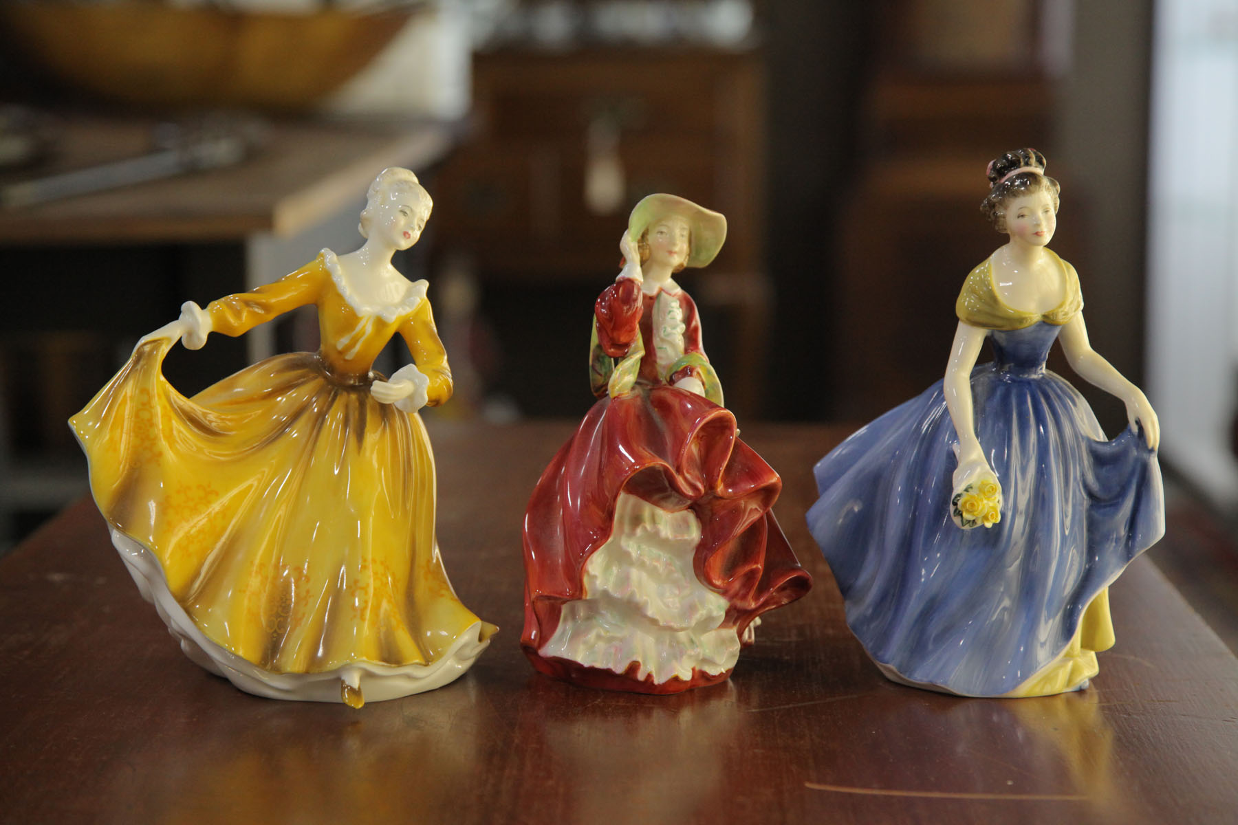 Appraisal: THREE ROYAL DOULTON FIGURES English th century Top o'the Hill