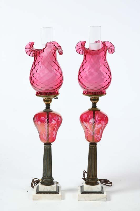 Appraisal: PAIR OF KEROSENE LAMPS Stepped marble bases fluted columns iridescent