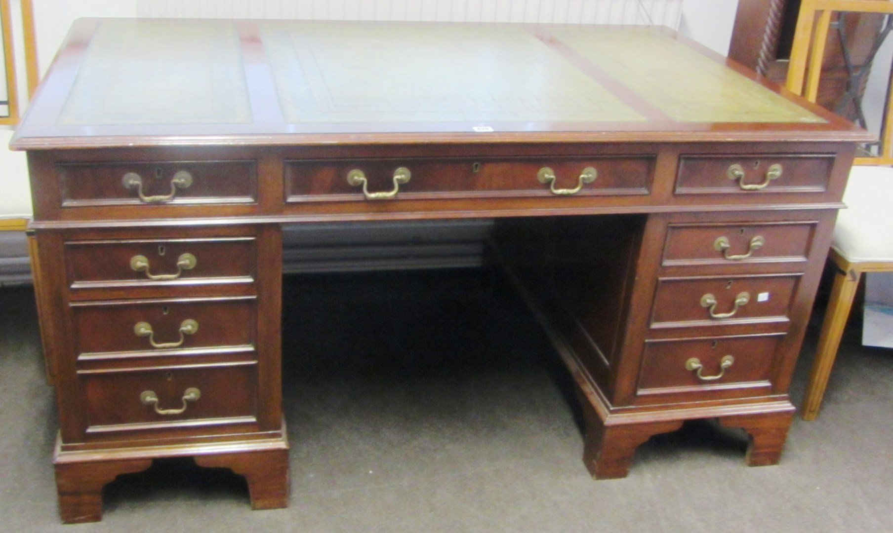 Appraisal: An th century style mahogany pedestal desk with nine drawers