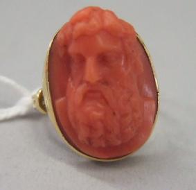 Appraisal: A gold mounted oval coral cameo ring carved as a