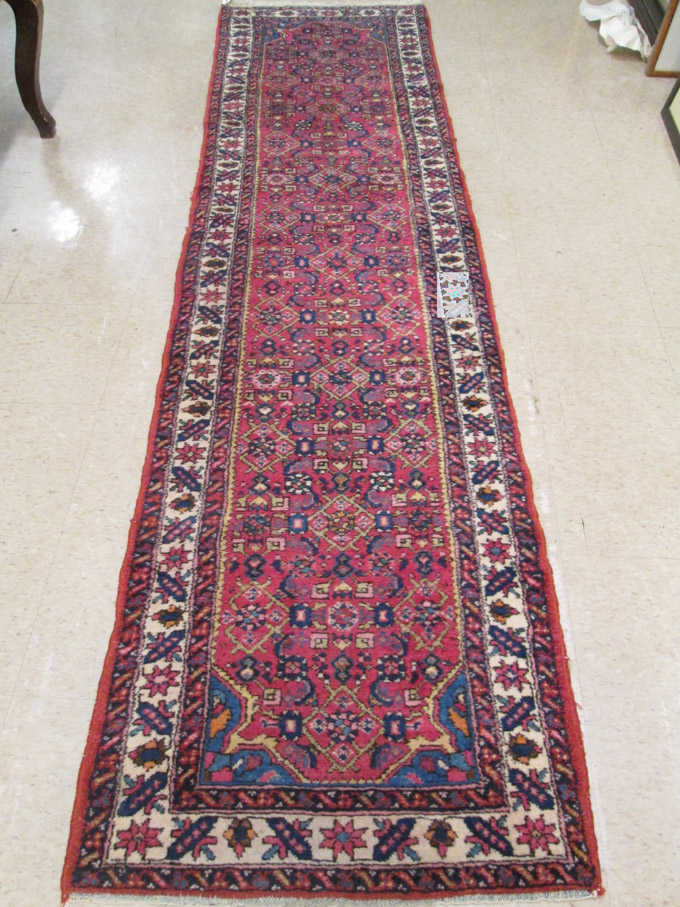 Appraisal: HAND KNOTTED PERSIAN RUNNER Herati floral motif on rose ground