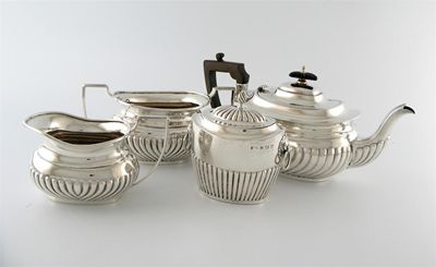 Appraisal: A three-piece silver tea set with a matching silver tea