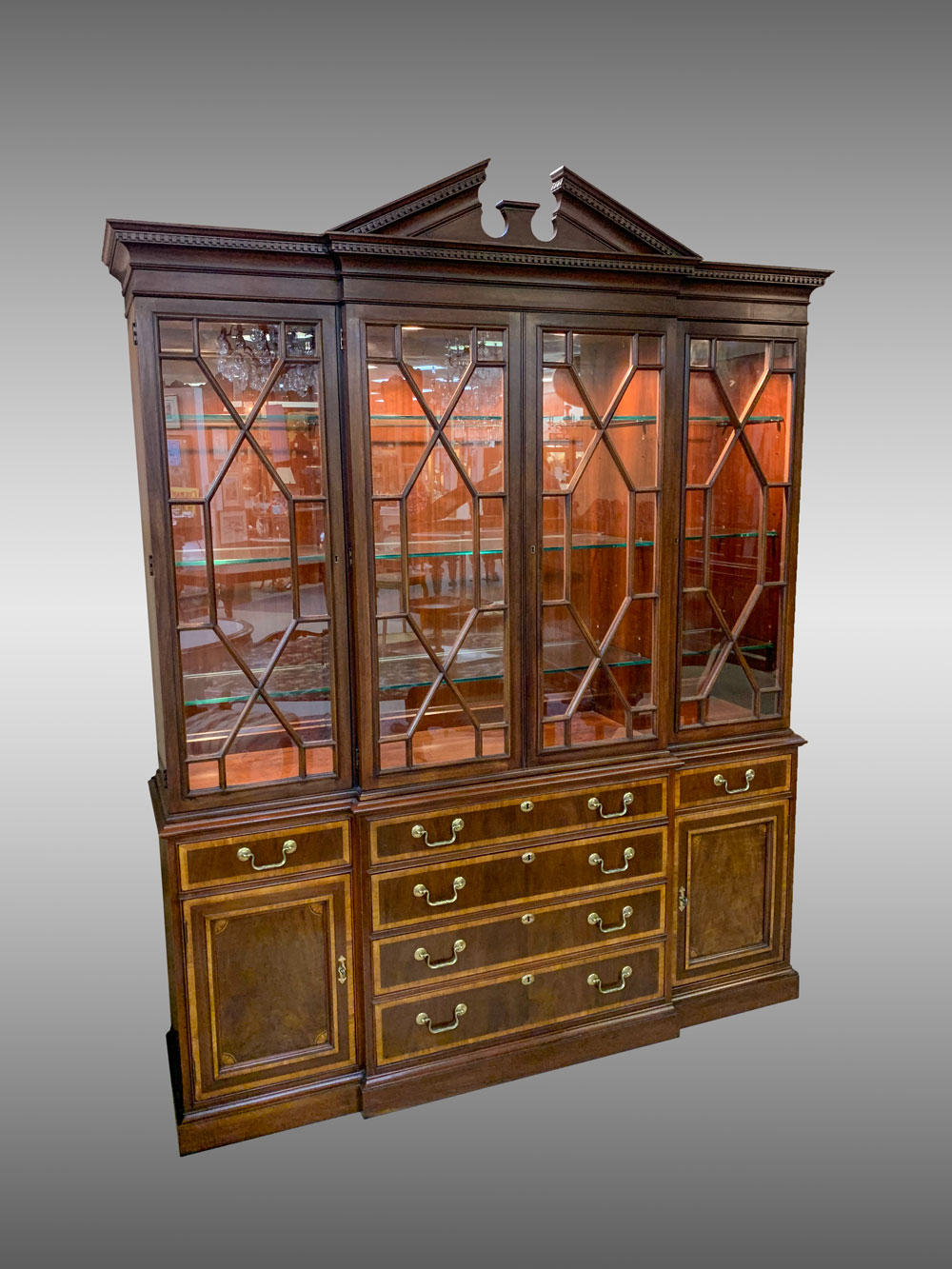 Appraisal: BANDED MAHOGANY BREAKFRONT CURIO light door curio with surmounting dental