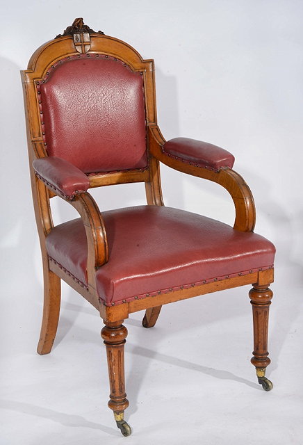 Appraisal: A LARGE VICTORIAN CARVED OAK ARMCHAIR with armorial crest scroll