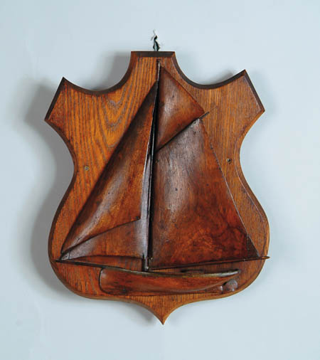 Appraisal: WOOD CARVED SAILBOAT WALL PLAQUE Shield-shaped back has single mast