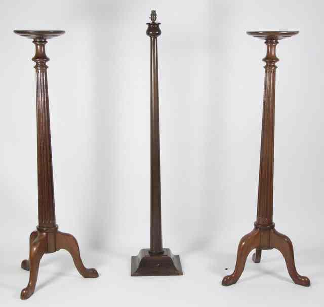 Appraisal: A pair of mahogany torch res each with circular top