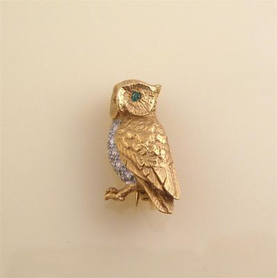 Appraisal: A diamond set gold owl brooch With emerald eyes cm