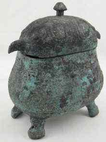 Appraisal: An bronze oval vessel and cover on four feet and