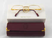 Appraisal: A pair of must de Cartier gilt half rim prescription