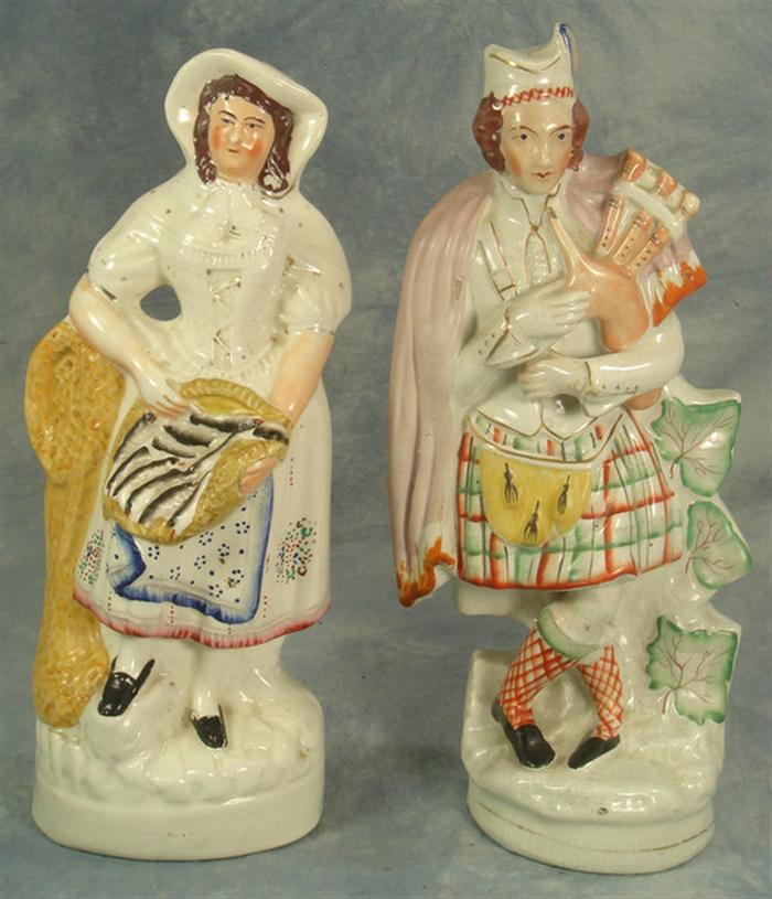 Appraisal: Staffordshire figurines Fisherwoman man with bagpipes h Estimate -