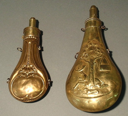 Appraisal: Two brass and copper powder flasks with relief decoration l