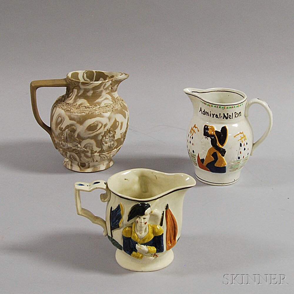 Appraisal: Three English Pottery Pitchers a Herculaneum agateware pitcher with grapevine