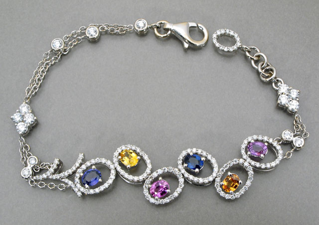 Appraisal: DIAMOND COLOR GEMSTONE AND EIGHTEEN KARAT WHITE GOLD BRACELET featuring