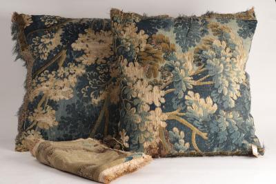 Appraisal: A pair of Brussels verdure tapestry cushions and a cushion