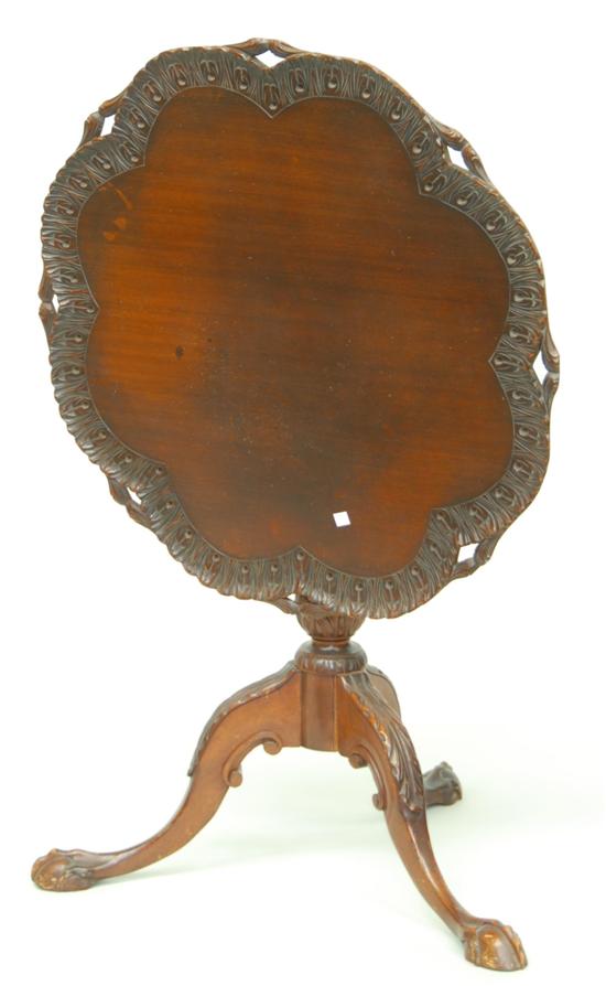 Appraisal: TILT TOP TABLE Heavily carved mahogany ca 's